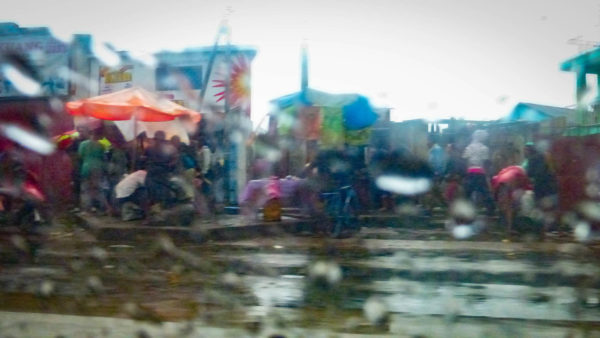 Photographie de Madagascar. Vue à travers une vitre de la 4L taxi, dans le quartier d'Anosybe, à Antananarivo.